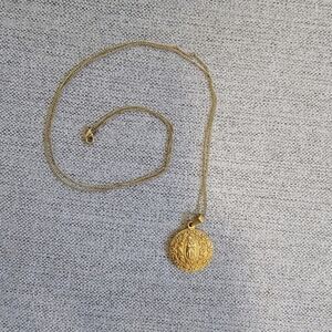 Plated gold costume necklace featuring Vigin Mary pendant